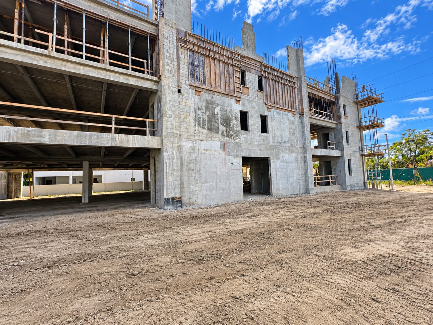 Masonry core walls and upper floors of the Sunset Square building under construction, September 2026